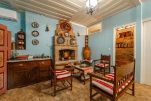 a living room with chairs and a fireplace at Leda Hamam House in Plomari