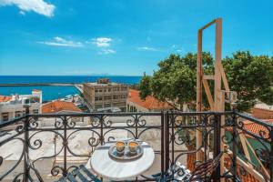 a balcony with a table and a view of the ocean at Leda Hamam House in Plomari