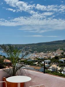 a balcony with a table and a view of a city at Hotel Cadaqués1962 by Fimedhotels in Cadaqués +93 photos