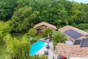 an aerial view of a house with a pool and solar panels on the roof at Chalet En Périgord Vert in Sainte-Croix-de-Mareuil