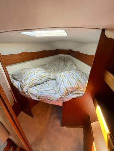 an overhead view of a small bed in a boat at Voilier Miraflores in Cherbourg en Cotentin +4 photos