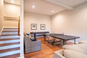 a living room with a ping pong table and stairs at The Overlook at Lake James in Nebo