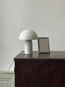 a white lamp sitting on top of a table at Orphé37, grand appartement cocon au cœur de la Gascogne artistique in Lectoure