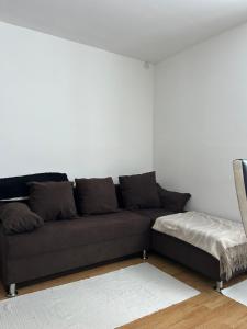 a couch in a living room with a white wall at Stan na dan Čajniče in Čajniče
