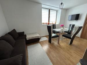 a living room with a couch and a table at Stan na dan Čajniče in Čajniče