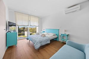 a bedroom with a bed and a couch and a window at Villa del Mar in Pula +20 photos