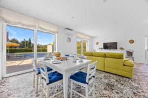 a living room with a table and a yellow couch at Villa del Mar in Pula