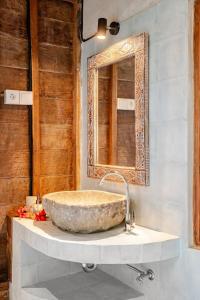 a bathroom with a large stone sink and a mirror at Green labak 2 in Silebeng +30 photos