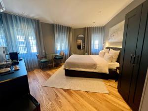 a bedroom with a bed and a table and chairs at Auberge de Vianden in Vianden