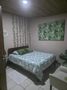 a bedroom with a bed and a painting on the wall at Apartamento Rustico in Fortuna