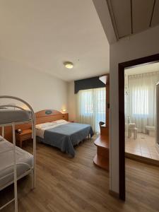 a bedroom with two bunk beds and a bathroom at Hotel Costa Verde in Pineto +158 photos