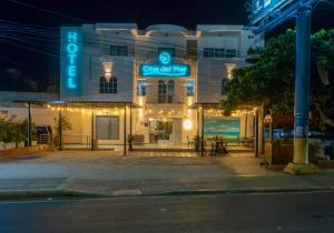 a building with a sign for a seafood restaurant at night at Olas del Mar Hotel by GHO Hoteles in Santa Marta