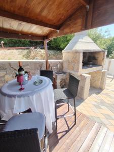 a table and chairs on a patio with a fireplace at Vila Ema Dramalj in Dramalj