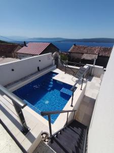 a swimming pool on the roof of a house at Vila Ema Dramalj in Dramalj +20 photos