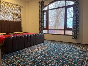 a bedroom with a bed and a large window at Dal frozen in Srinagar