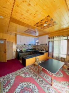a kitchen with a table in the middle of a room at Dal frozen in Srinagar