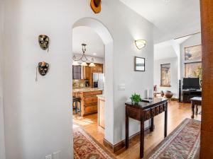 a kitchen and living room with a table and a dining room at Alpine Drive Chalet in Vail +24 photos