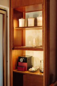 a wooden cabinet filled with dishes and a microwave at La casa del Ginkgo in Bobbio +27 photos