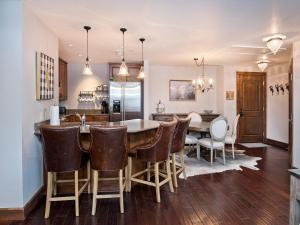 a kitchen and dining room with a table and chairs at Ascent Condo 111 in Avon