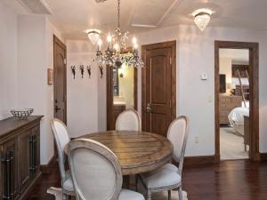 a dining room with a wooden table and chairs at Ascent Condo 111 in Avon
