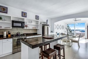 a kitchen with a large island with a counter top at Dog-Friendly Oceanfront Villa with Rooftop Patio, Pool Access, & Kitchen in Rosarito