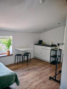 a room with a bed and a table and chairs at Wczasy z Wędką in Gardna Wielka