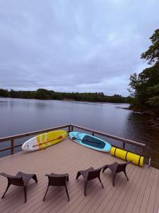 a boat with two chairs and a surfboard on the deck at The Overlook at Lake James in Nebo