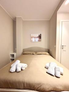 a bedroom with a large bed with two pillows at Alpine Escape 1BR Apartment A in Tarvisio