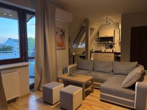 a living room with a couch and a table at Apartament Królewiecka in Płock