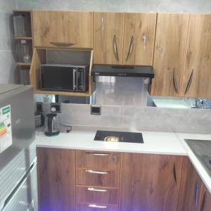 a kitchen with a stove and a microwave at Exclusive guest house in Modimolle +40 photos