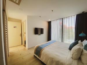 a bedroom with a large bed and a window at Tuệ House in Ấp Gia Thanh (1) +4 photos