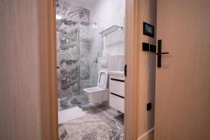 a bathroom with a sink and a toilet in it at Sarajevo Waves Aparthotel in Sarajevo +172 photos