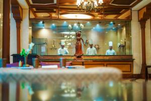 a group of chefs standing behind a counter in a restaurant at Avari Lahore Hotel in Lahore +27 photos