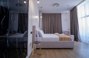 a hotel room with a bed and a couch at Sarajevo Waves Aparthotel in Sarajevo