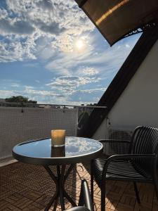 a table on a balcony with a candle on it at Apartament Królewiecka in Płock