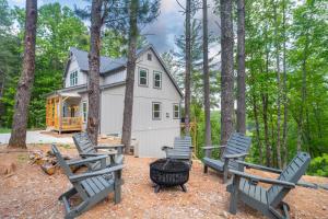 a group of chairs and a grill in front of a house at The Overlook at Lake James in Nebo