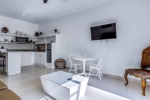 a white living room with a table and a kitchen at Dog-Friendly Suite with Kitchenette, Heated Outdoor Pool, Hot Tub, Terrace, AC in Rosarito