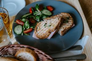 a plate of food with a sandwich and a salad at Penzion Pod Kašnou in Frýdek-Místek