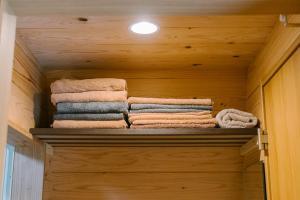 a pile of towels sitting on a shelf in a room at 自然満喫 野上平ロッジ in Kirishima +62 photos