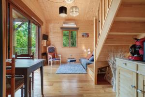 a room with a staircase in a wooden house at Chalet En Périgord Vert in Sainte-Croix-de-Mareuil