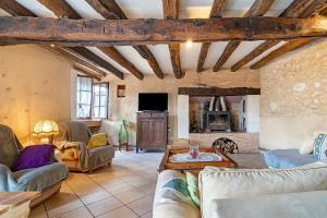 a large living room with couches and a tv at Le Séchoir D'Alice in Saint-Germain-du-Salembre