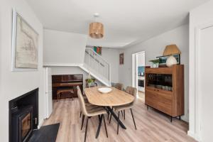 a dining room with a table and chairs and a piano at Willow Cottage, North Street in St. Andrews +12 photos
