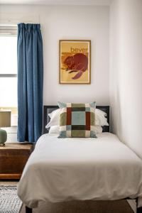 a bedroom with a bed with a pillow on it at Willow Cottage, North Street in St. Andrews