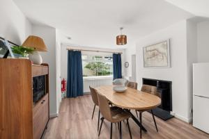 a kitchen and dining room with a wooden table and chairs at Willow Cottage, North Street in St. Andrews