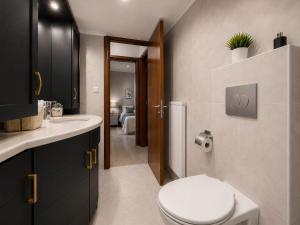 a bathroom with a toilet and a sink at Leas House in Preveza +27 photos