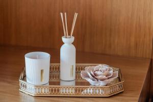 a tray with a vase and a candle on a table at Vistas da Villa in Cabeceiras de Basto