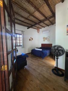 a room with two beds and a table in it at Pousada da Praia in Paraty