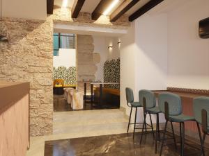 a bar in a restaurant with blue stools at Hotel Boutique Porta Ferrisa in Alicante