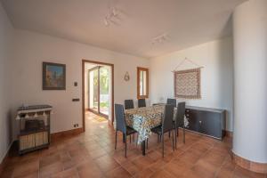 a dining room with a table and chairs at Breathtaking Sea Views & Jacuzzi in Cefalù in Cefalù