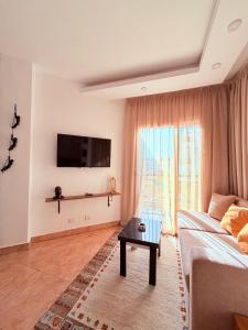 a living room with a couch and a table at Jasmine Resort & Aqua park in Sharm El Sheikh